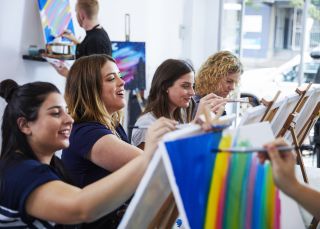 Attendees enjoying a painting class at Pinot & Picasso in Penrith, Sydney