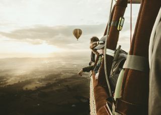 People enjoying a hot air balloon ride over the Hunter Valley