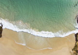 Scenic aerial views overlooking Horseshoe Bay Beach in South West Rocks, Coffs Harbour, North Coast