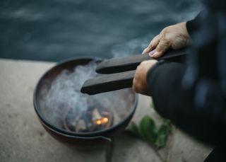 Margret Campbell performing a smoking ceremony at Blues Point Reserve, Blues Point in Sydney as part of the Dreamtime Southern X experience