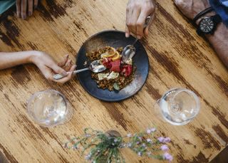 Couple enjoying food and drink at Zecca Restaurant, Griffith