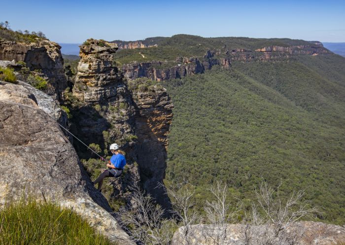 Woman abseiling at Cahills Lookout, Katoomba in the Blue Mountains