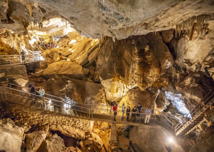 Small group enjoying a tour through a cave system at Jenolan Caves in the Blue Mountains