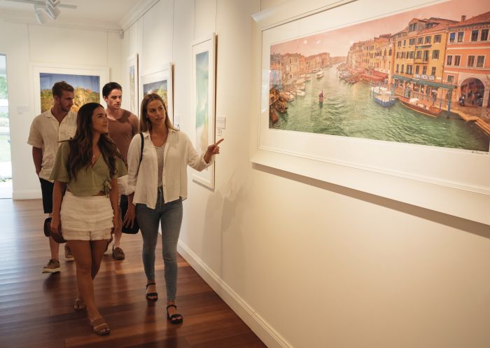 Visitors viewing framed photographs at the Ken Duncan Gallery, Erina Heights, Gosford 