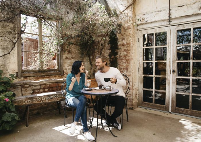 Couple enjoying food and drink at Junee Licorice and Chocolate Factory in Junee, Riverina