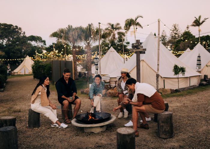 Friends roasting marshmallows and drinking hot chocolate by the pit fire at The Hideaway - Cabarita Beach - North Coast