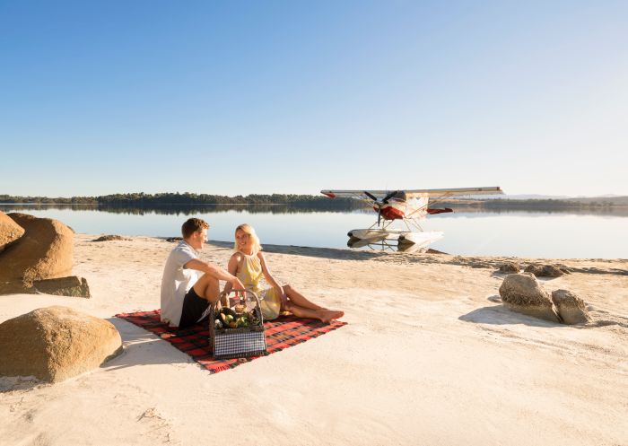 Couple having a picnic by Coila Lake in Tuross Head, Batemans Bay Area, South Coast