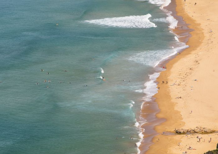 Beachgoers enjoying a day out at Stanwell Park Beach in Stanwell Park, Wollongong