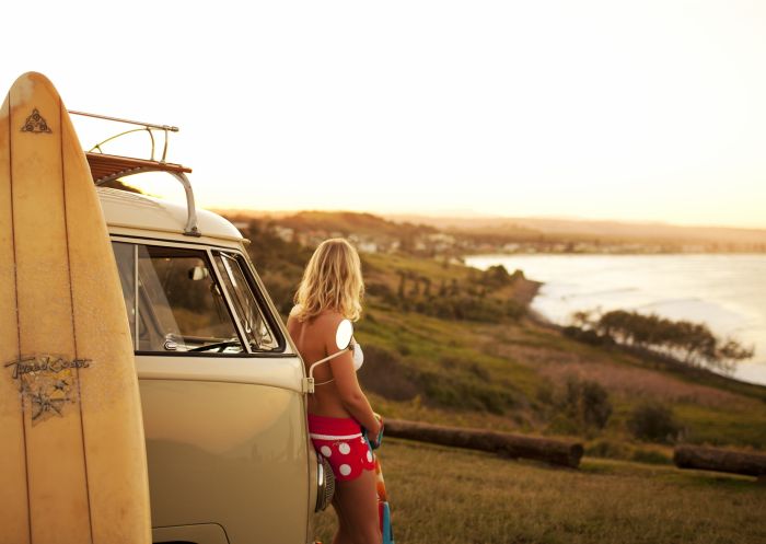 Surfer preparing to head into the ocean at Lennox Head in Byron Bay, North Coast