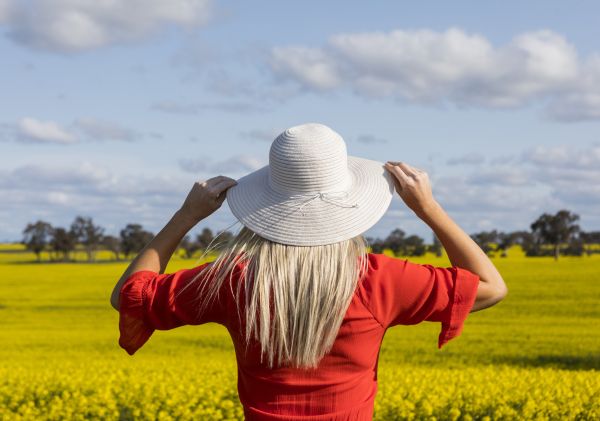 Woman on the Canola Trail viewing the canola fields in Sebastapol in the Riverina region