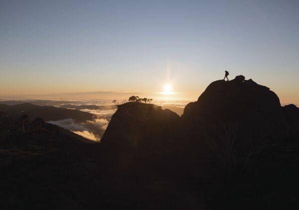 Hiker enjoying a scenic sun set at Kosciuszko National Park, Snowy Mountains