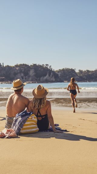 Family enjoying a visit to McKenzies Beach, Malua Bay.