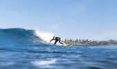 Surfer catching a wave at Werri Beach in Gerringong.