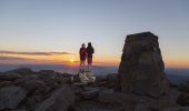 Couple watching the sun set at the summit of Mount Kosciuszko in Kosciuszko National Park