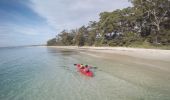 Mother and daughter kayaking along Sailors Beach near Moona Moona Creek in Huskisson, Jervis Bay