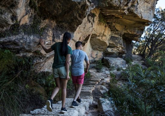 Couple enjoying a walk along the Wentworth Falls Track in the Blue Mountains National Park